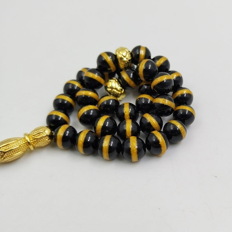 سبحة فخمه عقيق اسود بالمقلم الذهبيه