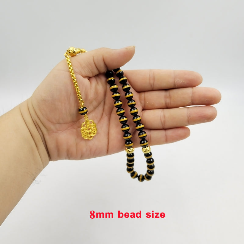 سبحة فخمه عقيق اسود بالمقلم الذهبيه