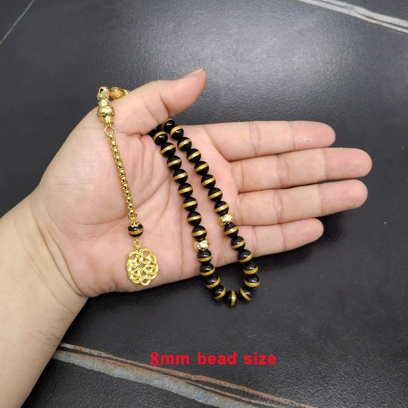 سبحة فخمه عقيق اسود بالمقلم الذهبيه